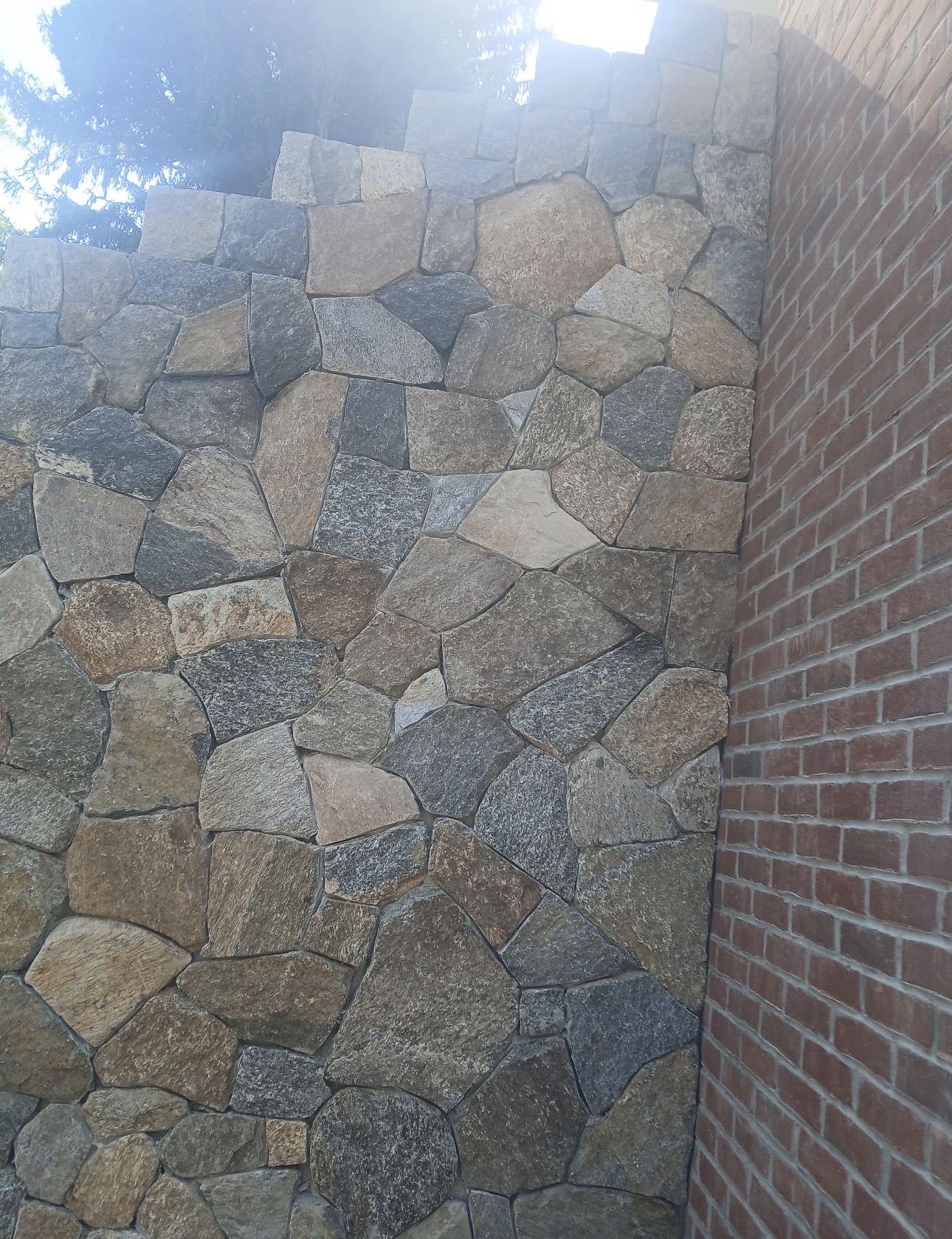 Natural thin stone veneer application on exterior foundation wall in Chatham MA by Castone Masonry