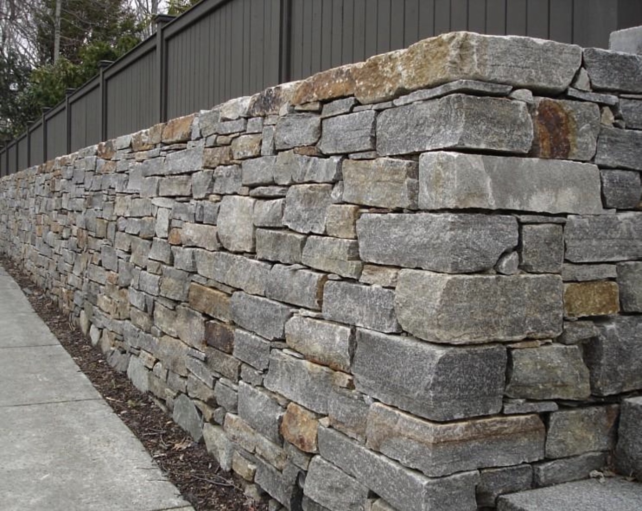 Structural mortared stone retaining wall installation in Wellesley MA